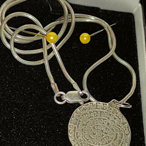 Necklace with 9.25 silver chain and Phaistos disc like new