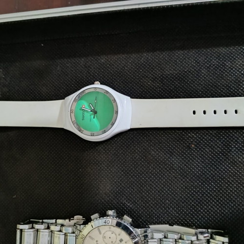 Swatch watch used with white silicone strap and green dial