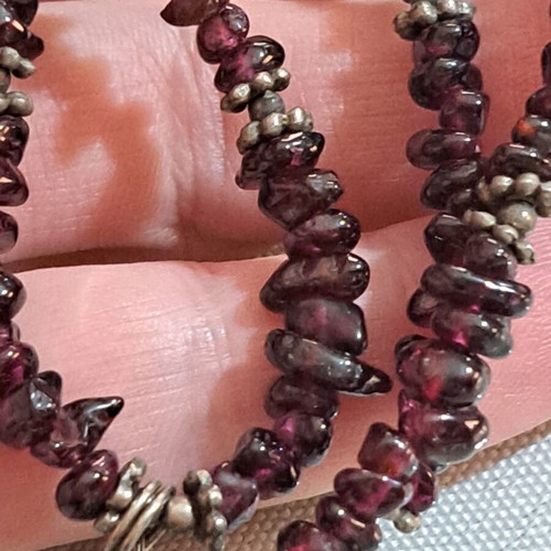 Necklace with purple beads and metallic butterfly and star charms