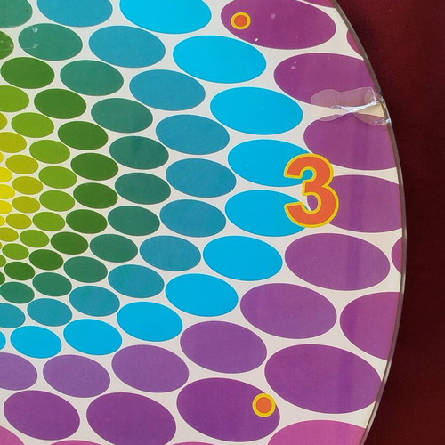 Glass pop art wall clock with spiral design and vibrant colors