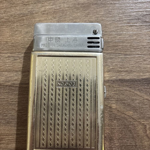 Sunflower lighter used with signs of wear, made in Shanghai