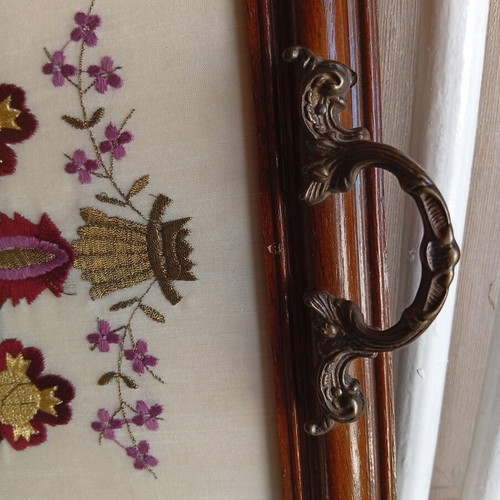 Decorative wooden tray with embroidered flowers and brass handles
