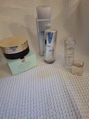 Empty Dior and Estèe Lauder cosmetic jars used, set