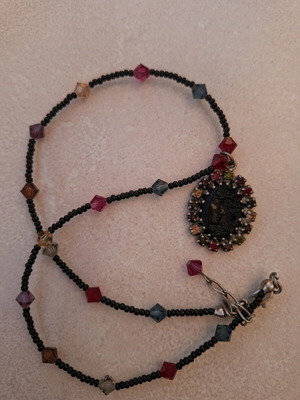 Necklace black with colorful stones and embossed face vintage like new