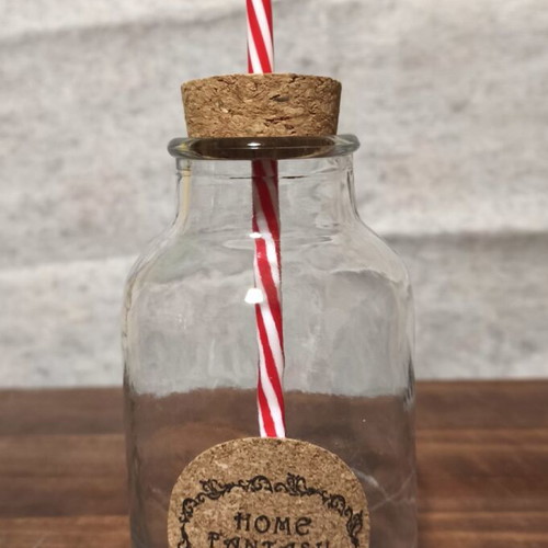 Glass with cork and straw used