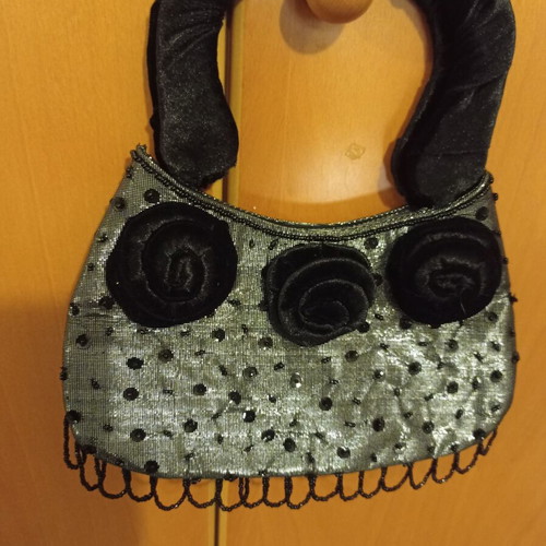 Women's handbag new with metallic silver-gray base and black velvet rosettes