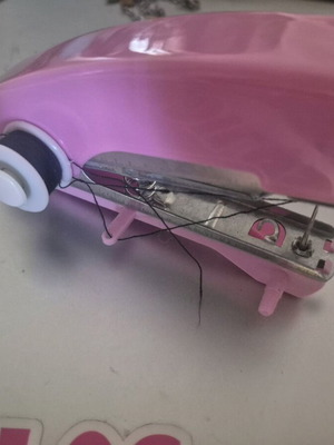 Mini handheld sewing machine like new with spare parts and accessories
