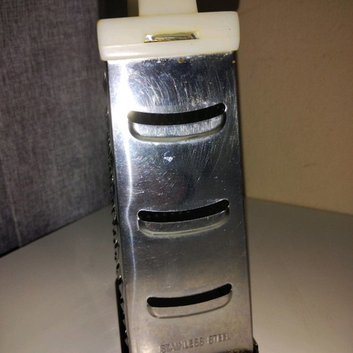 Cheese grater used, stainless steel with plastic handle