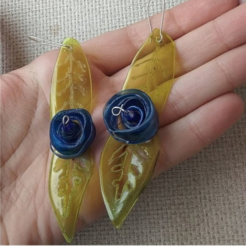 Earrings handmade from scratch with blue and green recycled plastic flowers and leaves