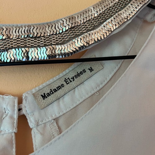 White blouse with silver details around neckline size M like new
