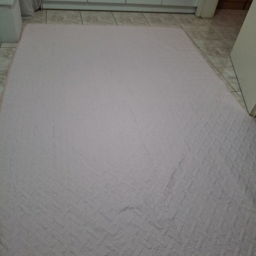Quilted bed cover in soft pink