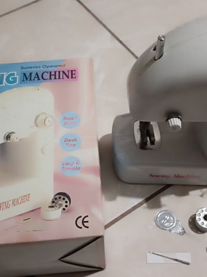 Mini handheld sewing machine used with batteries or adapter