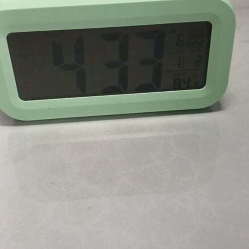 Digital tabletop clock used with alarm