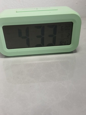 Digital tabletop clock used with alarm