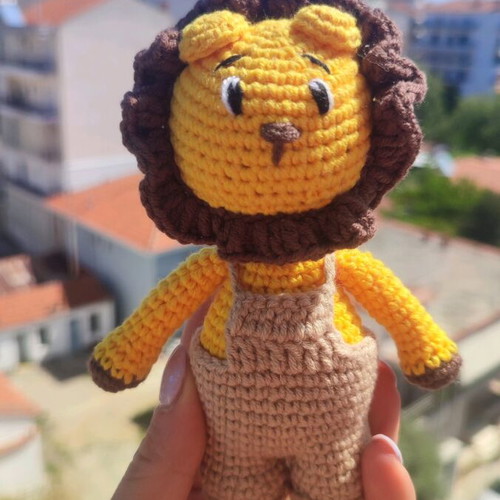 Crocheted lion toy handmade new with beige overalls