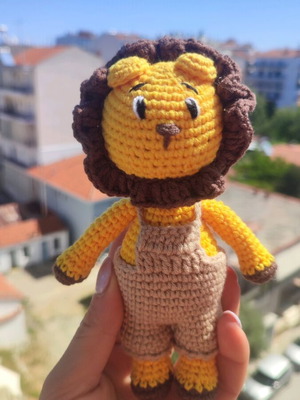 Crocheted lion toy handmade new with beige overalls