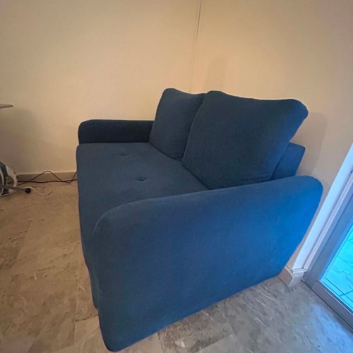 Blue two-seater sofa used with metal legs