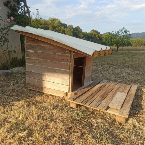 Custom wooden dog house with panel roof and removable veranda