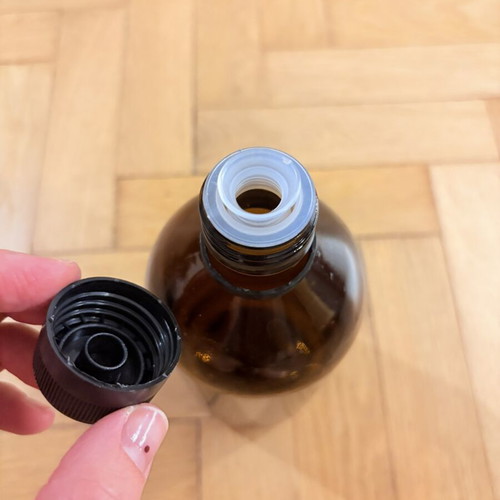 Brown glass pharmacy-style bottle with cap