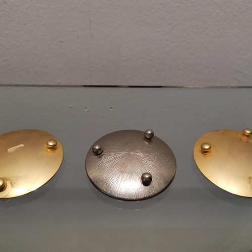 Set of three used metal candle holders with Arabic designs