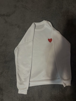 White sweatshirt with red heart