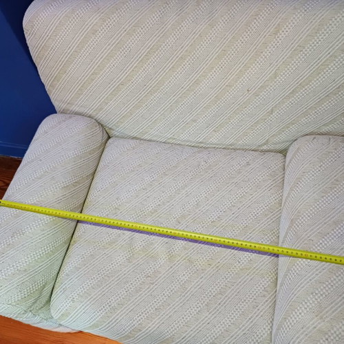Armchair with fabric upholstery and footstool used, wooden legs