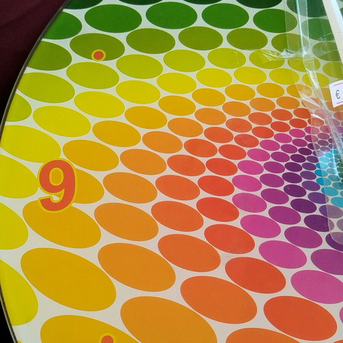 Glass pop art wall clock with spiral design and vibrant colors