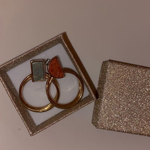 Gold hoop earrings used with detail on top part