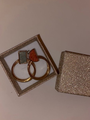 Gold hoop earrings used with detail on top part