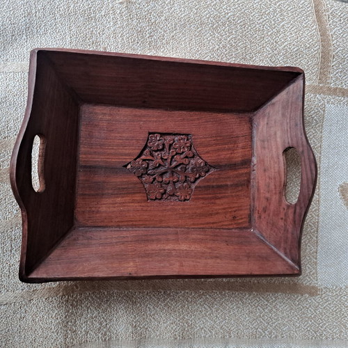 Vintage wooden serving tray used with carved floral motif