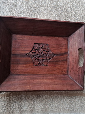 Vintage wooden serving tray used with carved floral motif