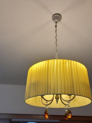 Ceiling light with brass parts and yellow lampshade