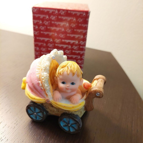 Decorative collectible baby stroller with baby and bottle like new