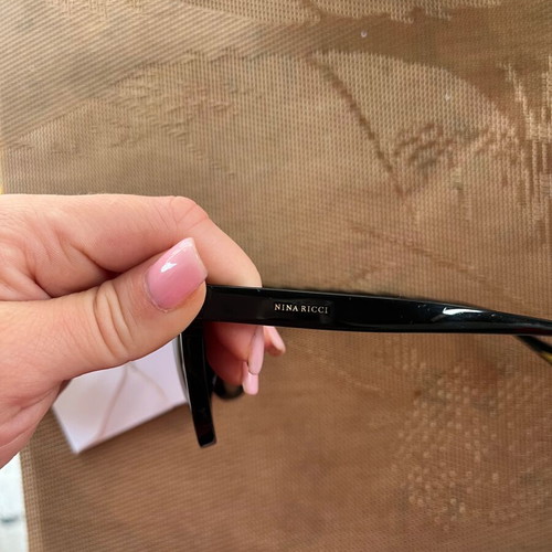 Nina Ricci SNR097 sunglasses like new, black oval acetate frame with chain design