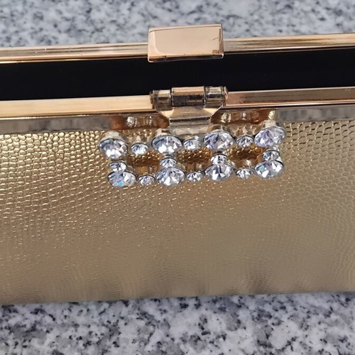 Gold evening clutch bag with rhinestones and metal frame