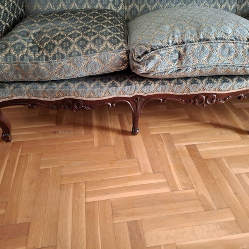 Vintage three-seater sofa and two antique armchairs with dark wood frame