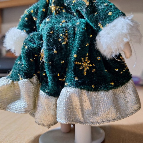 Porcelain doll on stand like new