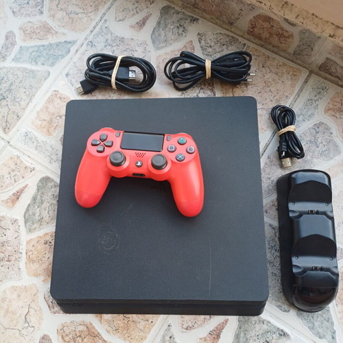 PlayStation 4 Slim 1TB console with red DualShock 4 and charging dock
