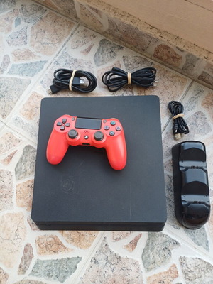 PlayStation 4 Slim 1TB console with red DualShock 4 and charging dock