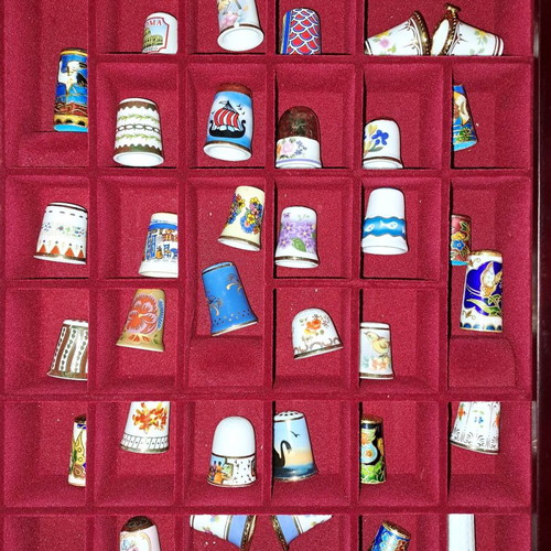 Porcelain thimble collection with wooden display case and book