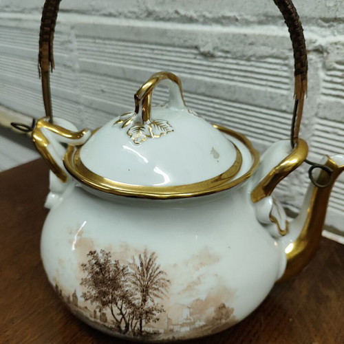 Antique porcelain teapot with wooden handle used