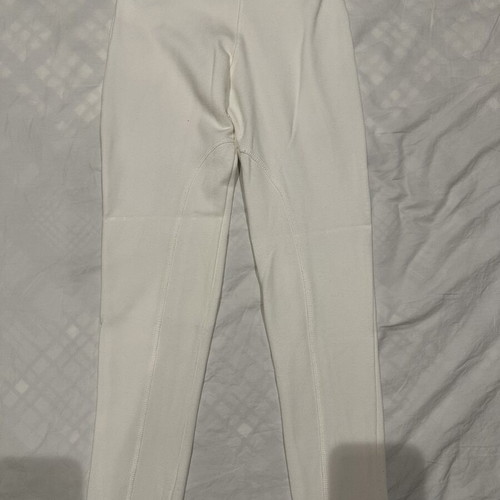 White elastic slim fit pants with ankle zippers