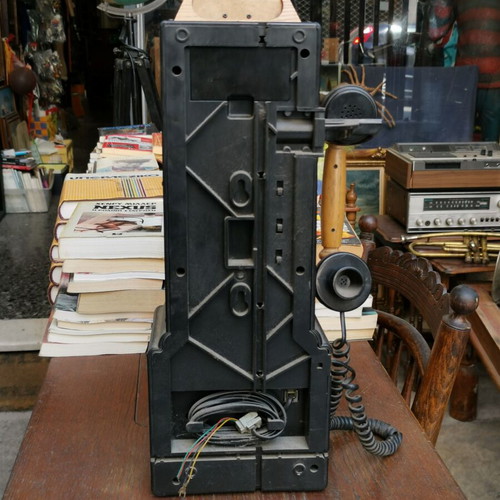 Vintage decorative wall telephone with clock used
