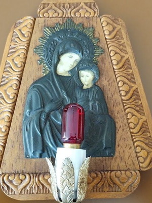 Small wooden religious icon used with embossed Virgin Mary and electric lamp
