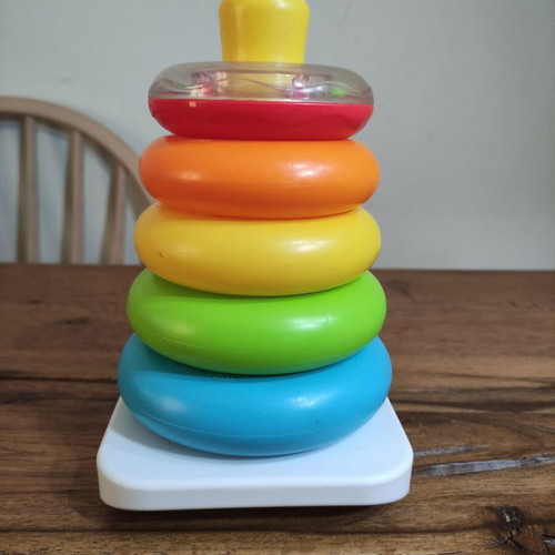 Fisher-Price stacking pyramid like new, 5 colorful rings with rattle base