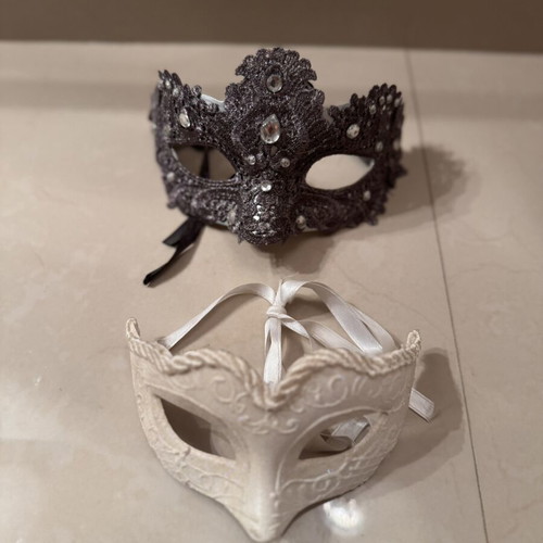 Two ornate masks like new, one gray and one white