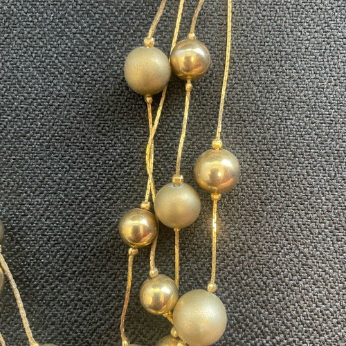 Statement necklace used with shiny and matte gold beads