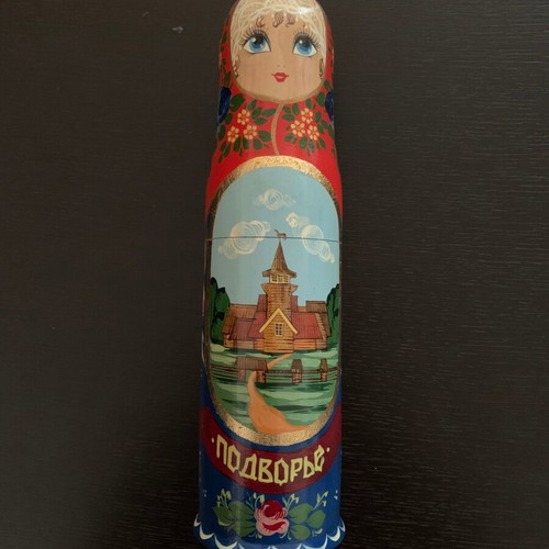 Old handmade wooden doll used with painted decoration