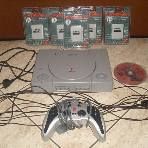 PlayStation 1 console used with controller, game, and memory cards