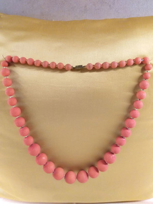 Orange-red necklace with textured stones used